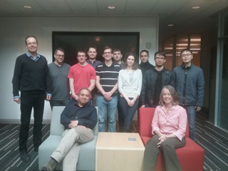 Group of Project 8 Yale workshop attendees standing, smiling, and posting at Wright Lab.